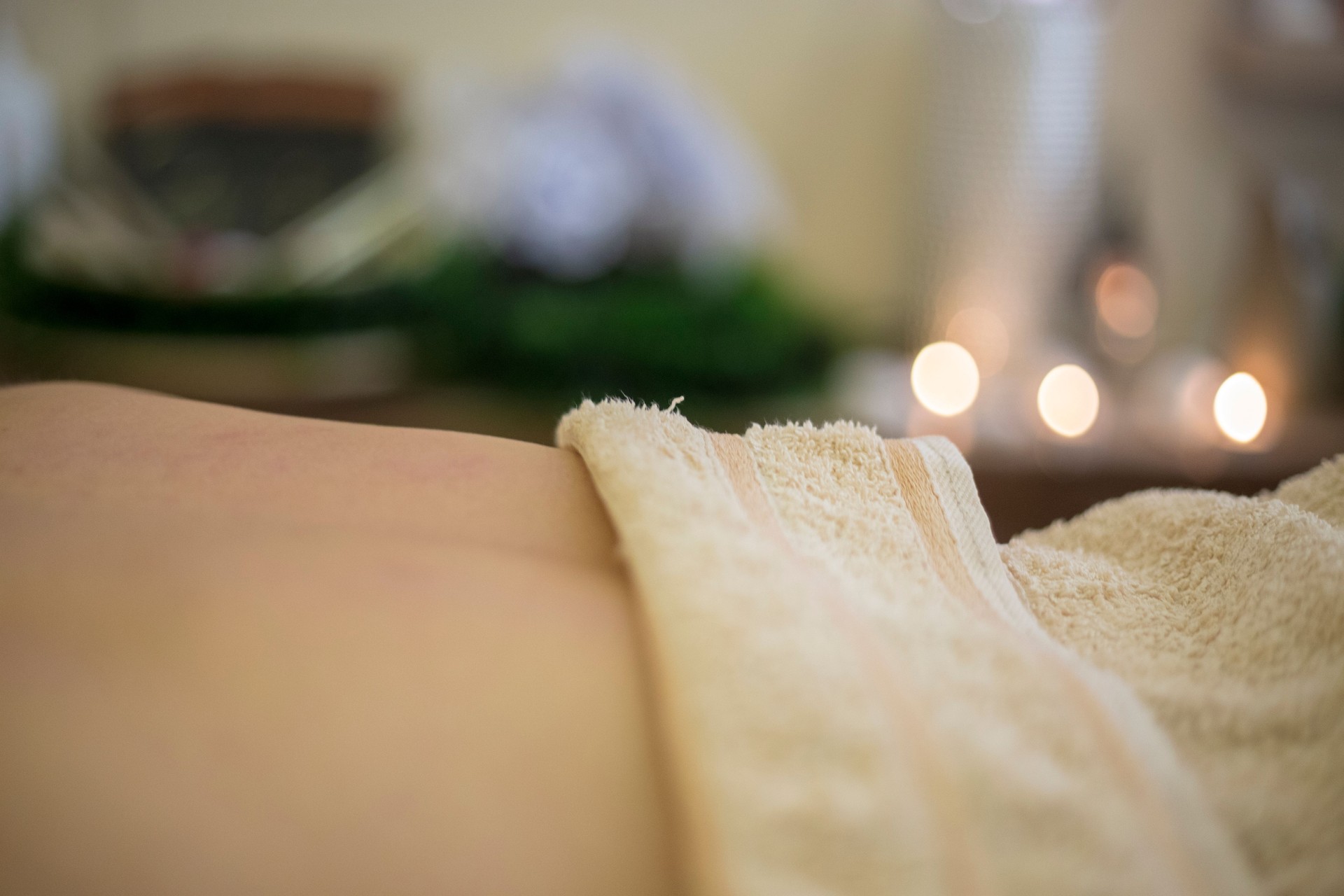 Luxury, wellness and Zen spa massage on a young woman back, relaxing and stress free at a resort or center. Female enjoying healing treatment by a masseuse, pamper while massaging for muscle relief